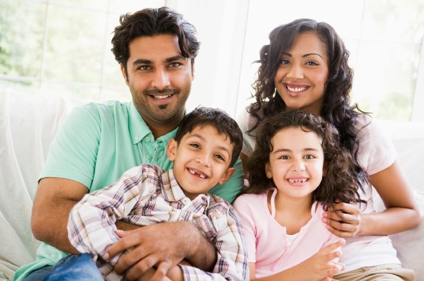 A family of four posing for the camera.