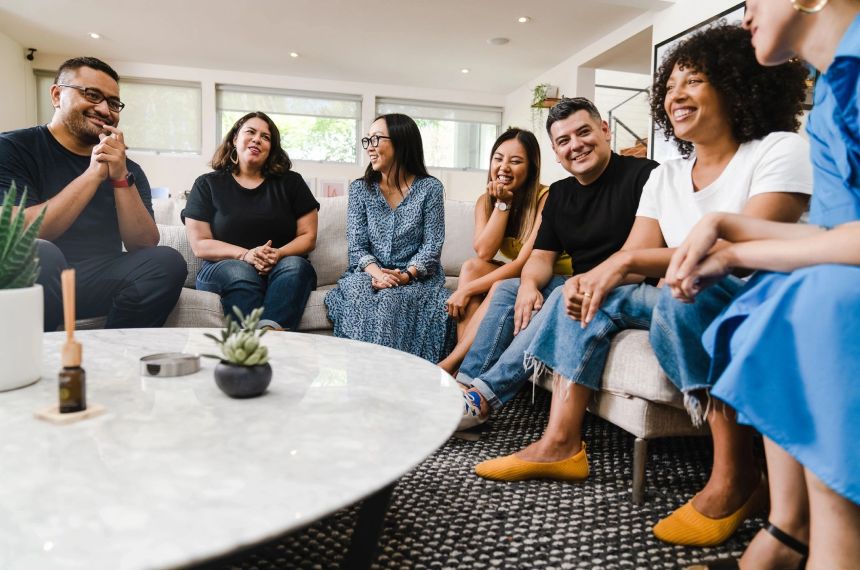 A group of people sitting around a table.