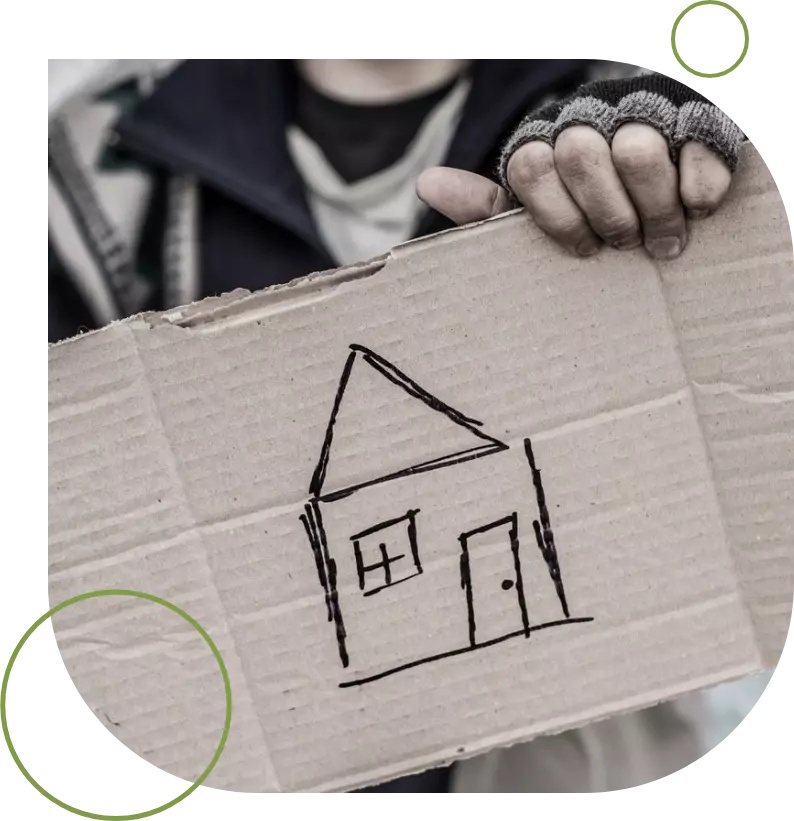 A person holding up a cardboard box with a house drawn on it.