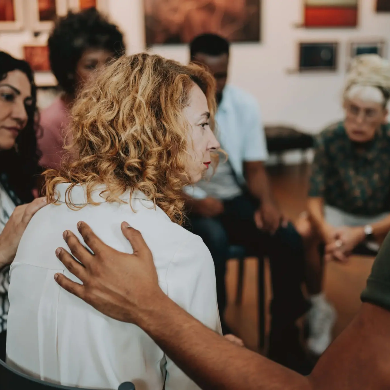 Support group session with comforting gesture