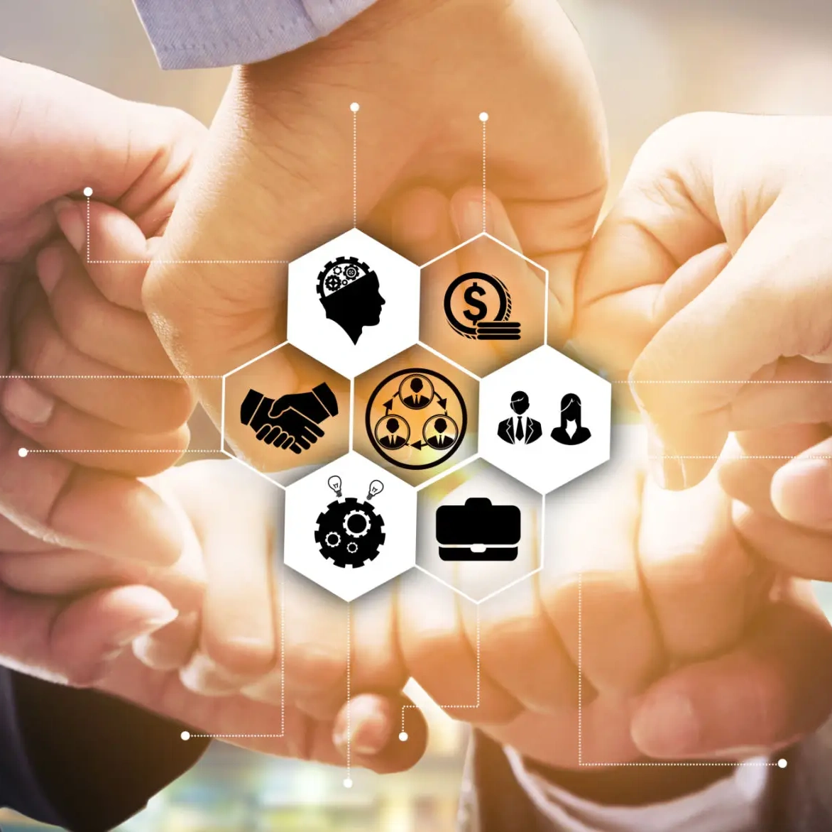 Hands connecting over business symbols