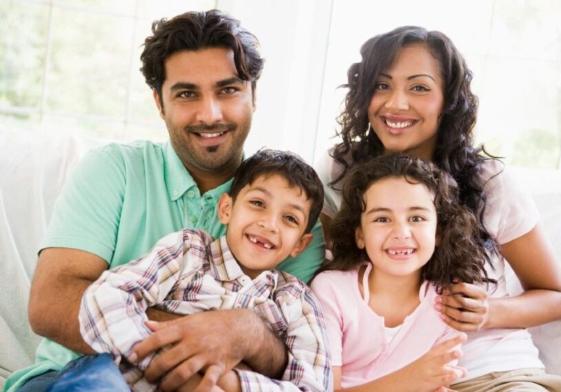 A family of four posing for the camera.